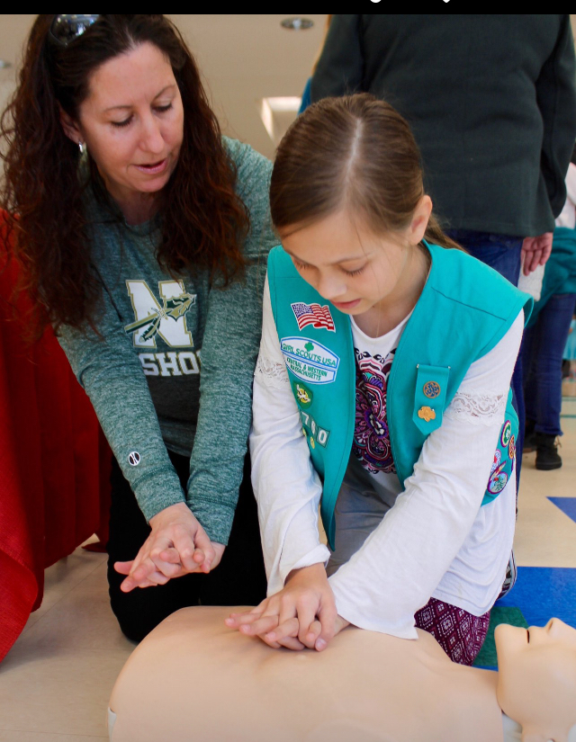 Nurse Sarah DelConte Cosentino teaching Hands-Only CPR to Girl Scout, Bella Paul.